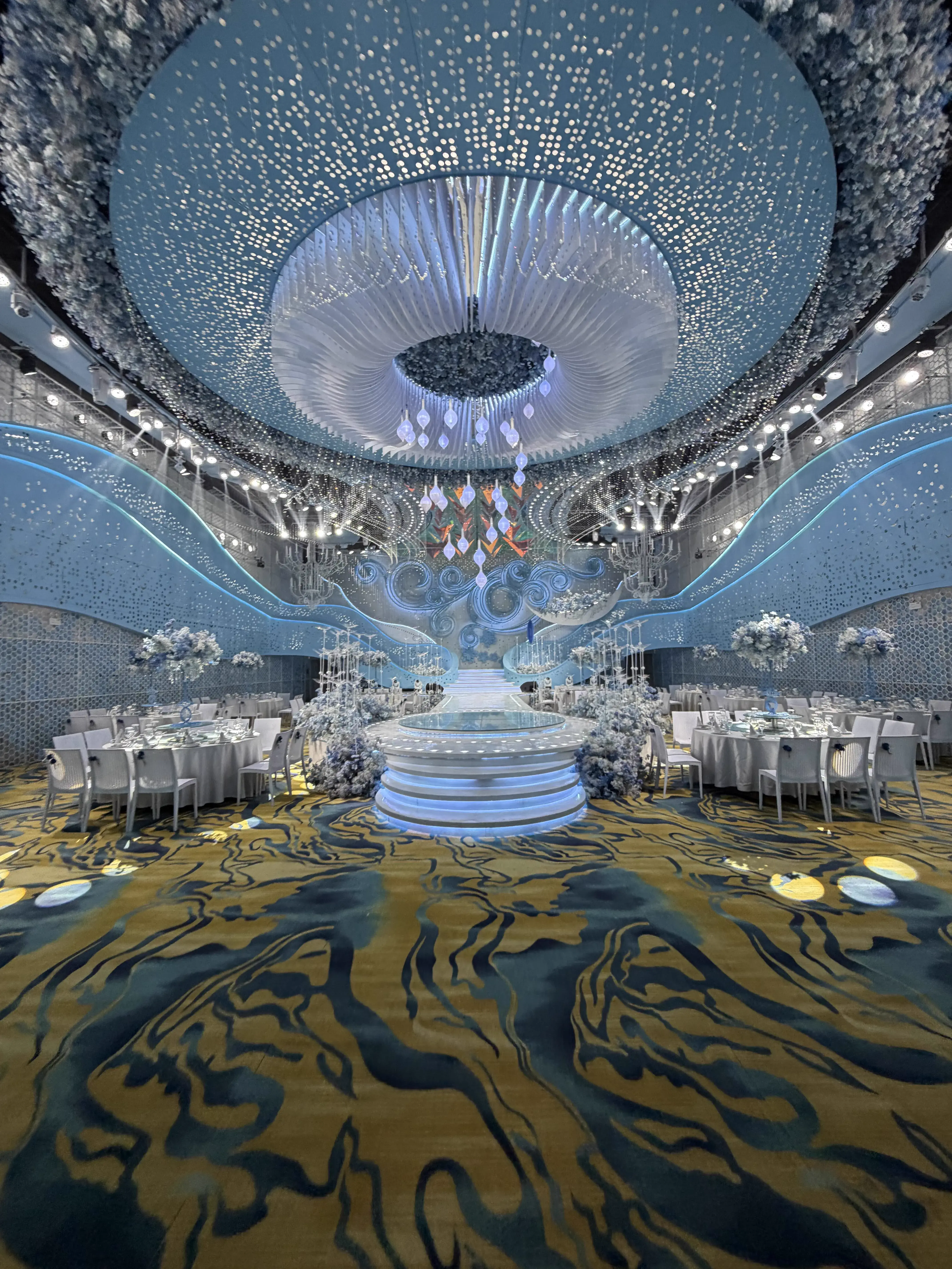 Ocean themed ballroom with panoramic starry sky ceiling and blue stage environment